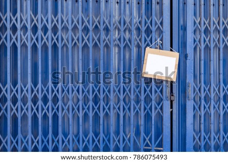 Paper Label hanger on Blue Iron Door, Aluminum folding door