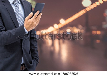 isolated business man hold the smartphone on the street at London, UK