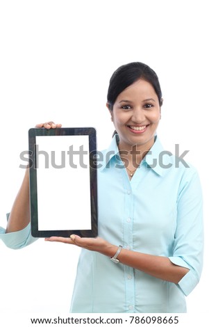 Happy young business woman showing tablet 