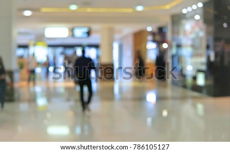 Blur background shopping center with people walking inside. Blur background busy modern mall with customer looking for product
