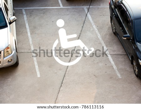 Cars parking with disability sign