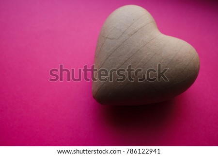 heart shape paper mache gift on pink backrop