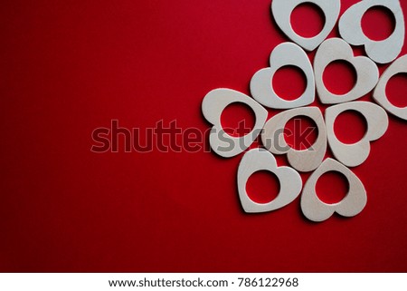 wooden hearts decoration composition on a red background. Valentine's day
