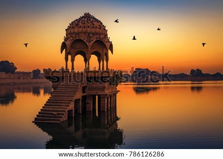 Ancient temple ruins at Gadi Sagar lake Jaipur Rajasthan at sunrise  Royalty-Free Stock Photo #786126286