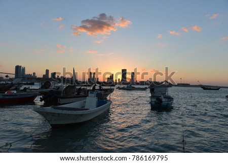 A view of the colourful sunset in Bahrain. Picture of the Manama skyline from the Muharraq coast. 