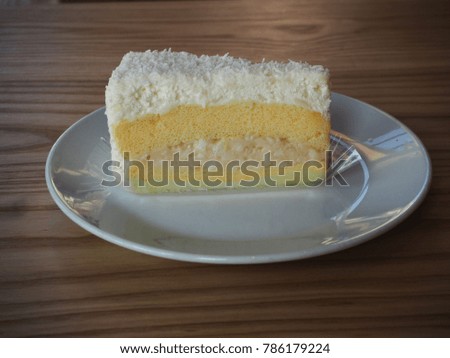 Coconut Cream Cake on wooden table