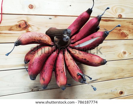 Red  banana on wooden floor  Used as a herb and very rare.