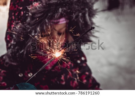 little girl in the snow and bengal fire