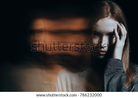 Young girl addicted to drugs with hallucinations against blurred background Royalty-Free Stock Photo #786232000