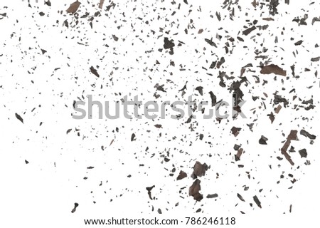 Burned, charred paper scraps isolated on white background, top view