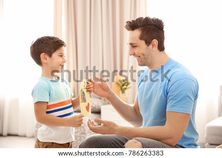 Little boy greeting his dad with Father's Day