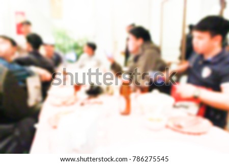 Blurred images of eating among friends.