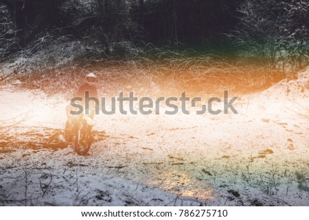 Rider man on a motorcycle Winter motocross. Skid on a snowy forest. the snow from under the wheels of a motorcycle Enduro. off road dual sport travel tour, active life style concept