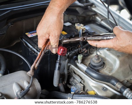 old man's hand fix pole car battery terminal with pliers Royalty-Free Stock Photo #786276538