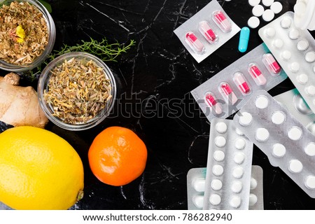 Alternative remedies and traditional pills to treat colds and flu. Natural medicine vs conventional medicine concept. Copy space. Royalty-Free Stock Photo #786282940