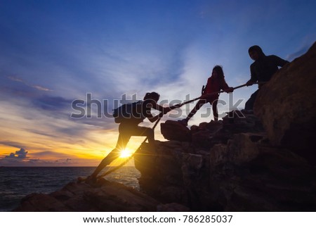 Silhouette of hikers climbing up on the mountain,team work and helping concept. Royalty-Free Stock Photo #786285037