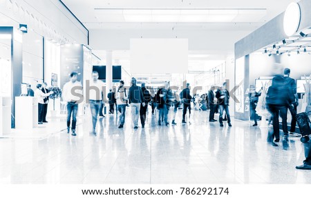 blurred people at a trade fair hall