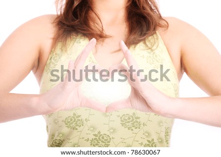 A picture of a woman creating a shape of a heart from her hands over her body