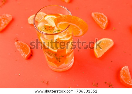 Orange fruit cocktail, detox water on orange background. Summer time
