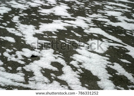 Tiled pavement covered with white snow. Winter holiday background