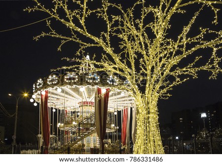 Carousel and Christmas (New Year holidays) decoration in Moscow (at night), Russia   