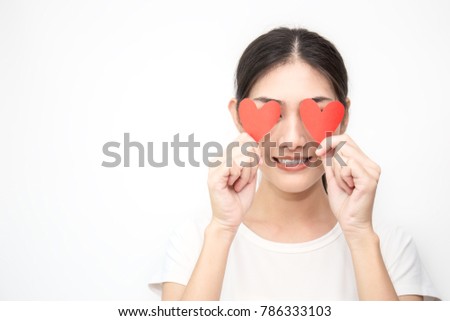 Portrait of girl holding red paper heart cover her face isolated on white background. Closeup Asian woman with red heart love valentines day concept