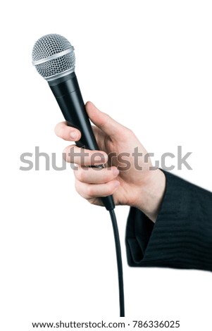 Close up of man's hand holding microphone isolated on white background