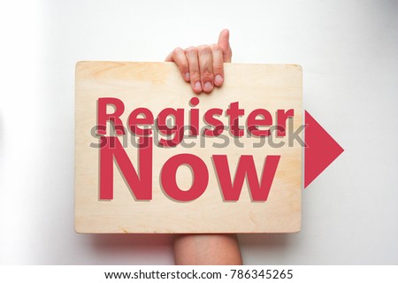 register now. concept button web site. hand holds a wooden tablet with text