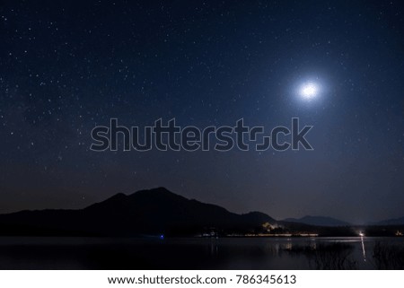 Mountains, rivers, moon and stars in the beautiful night sky. After sunset, the stars and moon shines on the sky.