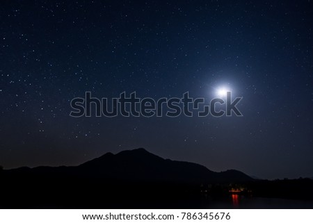 Mountains, rivers, moon and stars in the beautiful night sky. After sunset, the stars and moon shines on the sky.