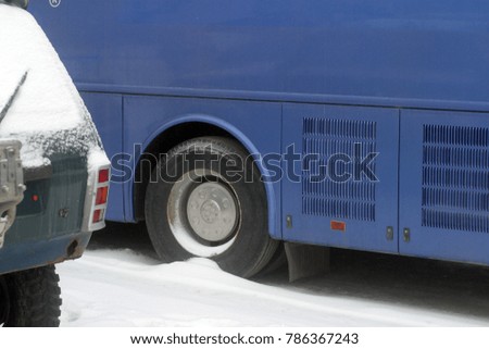 The car is covered with white snow. Winter background