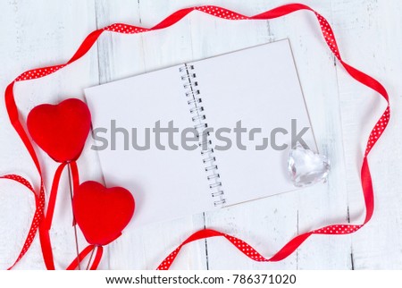 Valentines day toy hearts and notepad for your text. Top view on wooden table