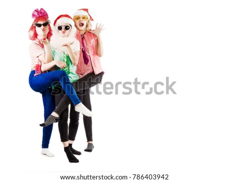 Portrait with copy space three pretty, charming girls having fun during a Christmas party