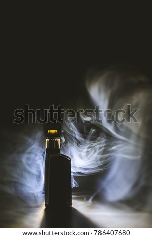 Vape mode and tank with dark background "This photo may contain blur image and grain due to low light and soft focus shot"