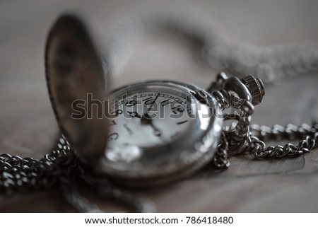 Old pocket watch on wooden background
