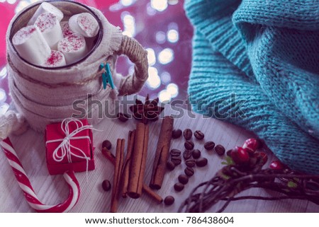 Warm winter mug with marshmallow, lollipop and gift. Cozy winter still life