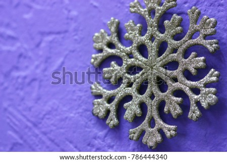 Snowflake ornament on the isolated lilac background is horizontal. Close up. Macro 
