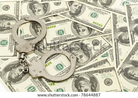 Handcuffs on money background, business security concept