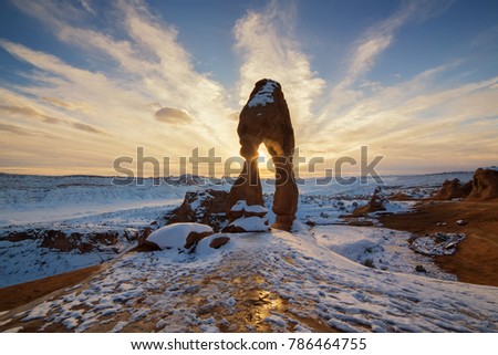This is the picture of Delicated Arch with snow during sunset at Arches National Park, Utah.