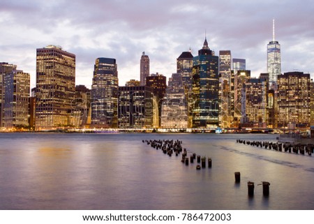 Lower Manhattan, New York City skyline with harbor after sunset at dusk