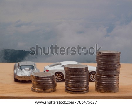  coin stack, saving money for a car ,  Sky background ,  business concept sign, symbol, idea.  

