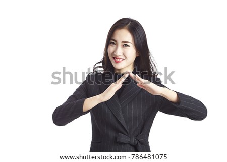 studio shot of a beautiful young asian businesswoman making a roof sign with hands, looking at camera smiling, isolated on white background.