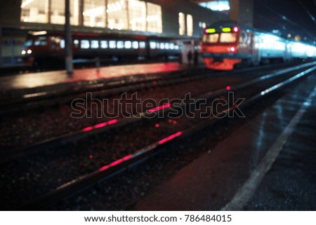 Two Red trains in station without motion