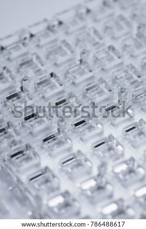 Abstract high-tech background. A sheet of transparent plastic or glass with the cut out holes. Laser cutting of plexiglass.