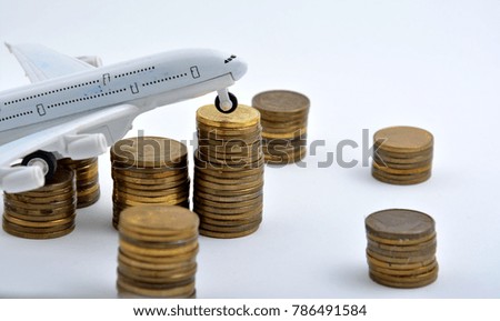 Plane plastic toy with coins isolated on white background