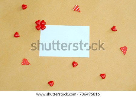 White paper note with mini red hearts background. Concept write message to send note on valentine's day, Happy birthday or special day. Copy space. Cute background. Flat lay.