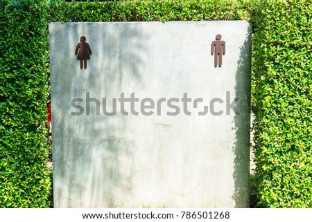 in front of public toilet room with male and female symbol for separate lavatory room for man and woman.