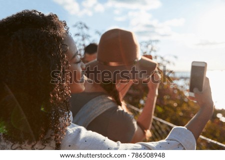 Group Of Tourists Taking Photos On Mobile Phones