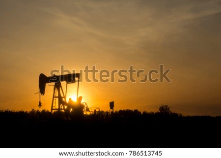 Oil Jack Silhouette With Sunset