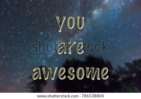words "you are awesome" written on blurred starry night sky background. motivation concept.